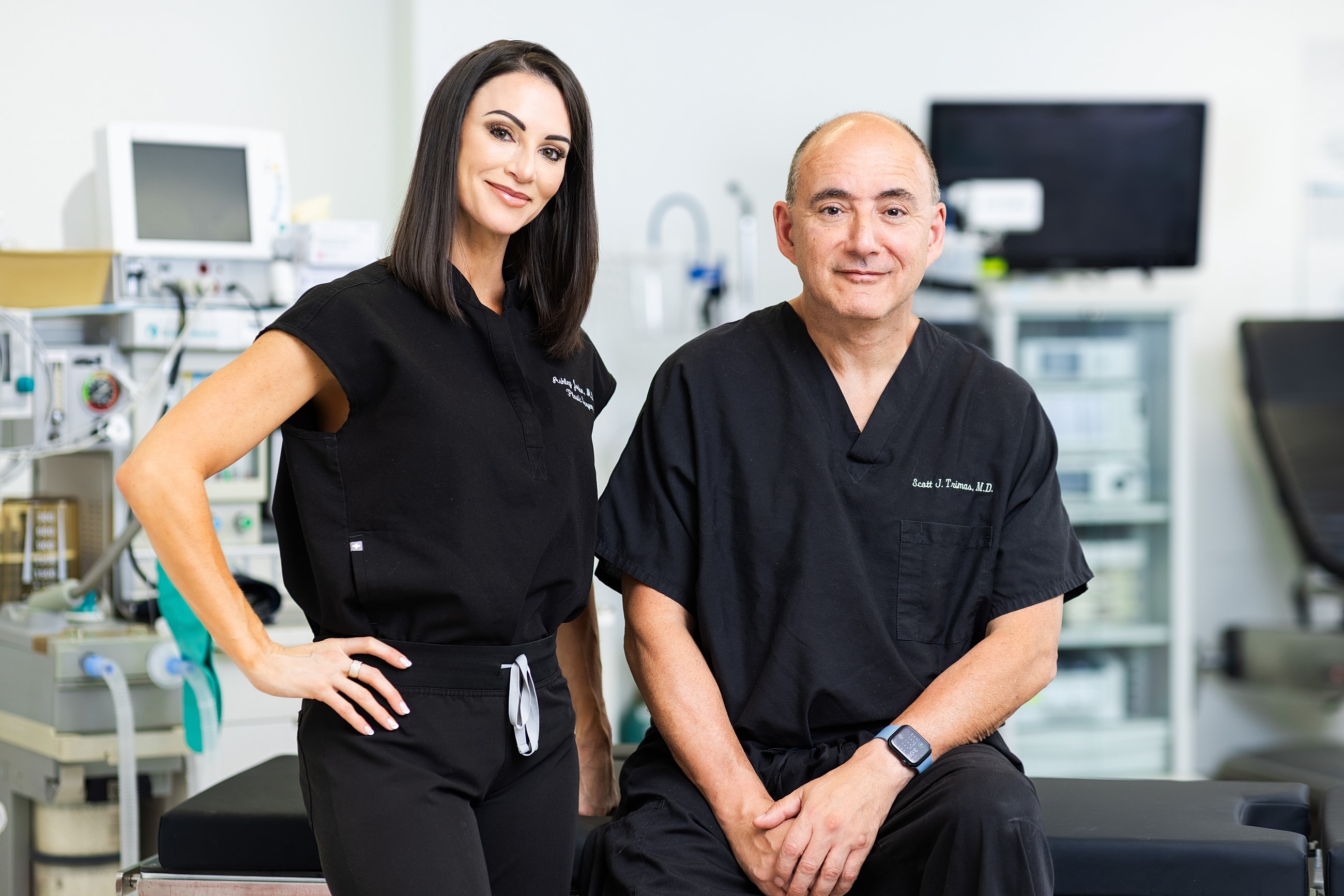 Doctors posing in a medical office setting.